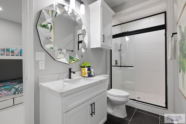 bathroom featuring tile patterned floors, vanity, toilet, and a shower with door