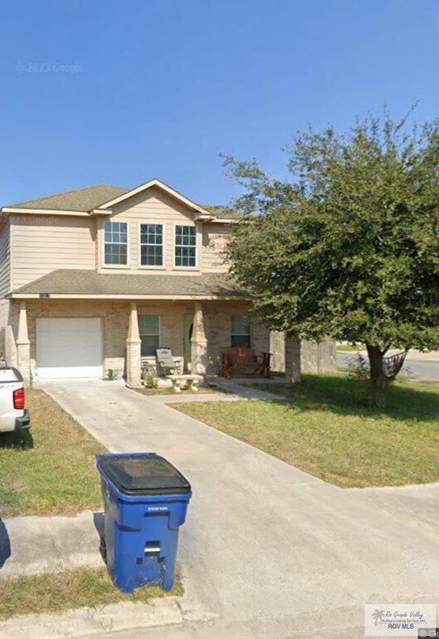 17211 Tangelo Ave, Harlingen, TX 78552 - view of front of home featuring driveway, a front yard, and a garage