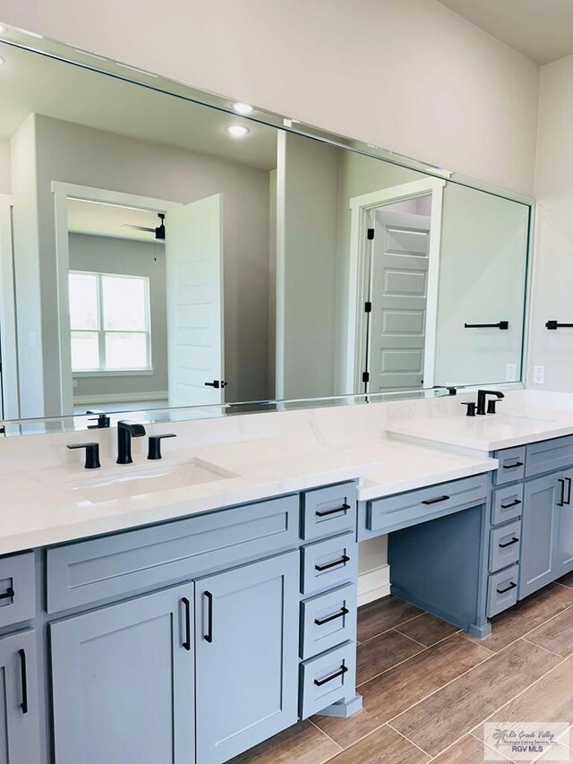 3617 Mattie Ln, Harlingen, TX 78550 - full bathroom with double vanity, wood tiled floors, and ceiling fan