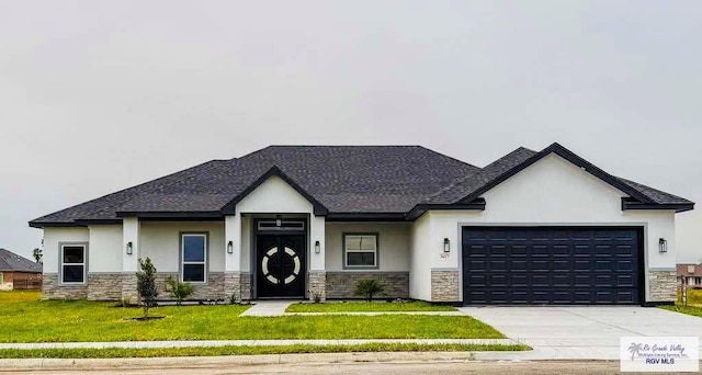 3617 Mattie Ln, Harlingen, TX 78550 - view of front of property featuring stone siding, stucco siding, a garage, and concrete driveway