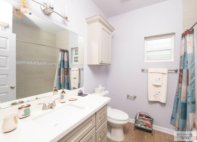 bathroom featuring walk in shower, toilet, vanity, and hardwood / wood-style flooring