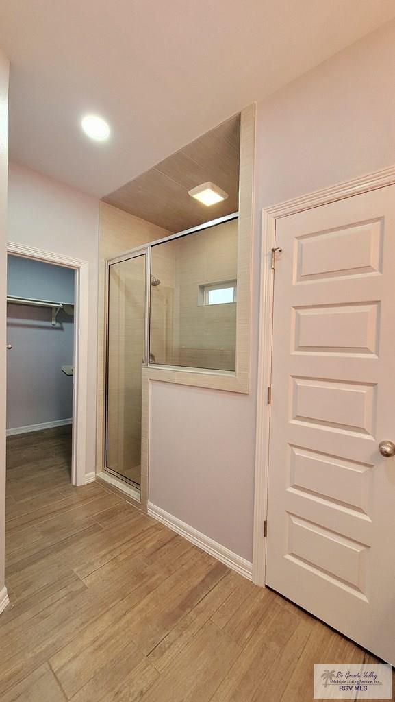 hallway with light hardwood / wood-style flooring