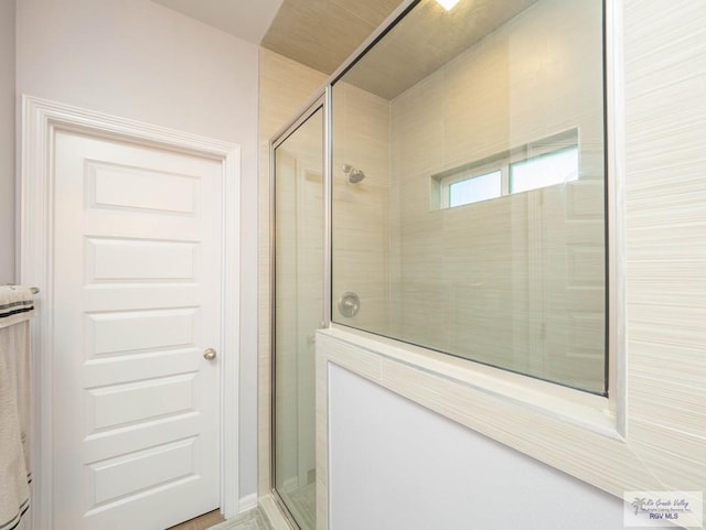 bathroom with a shower with shower door