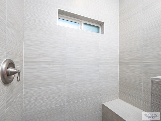 bathroom with a tile shower