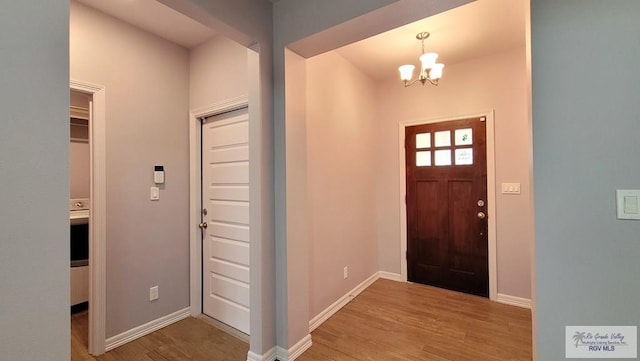 foyer featuring light hardwood / wood-style floors and an inviting chandelier