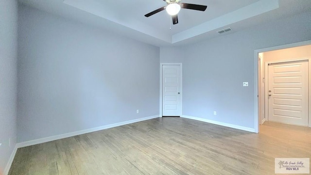 empty room featuring wood-type flooring and ceiling fan