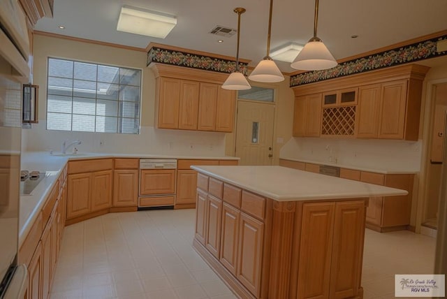 kitchen featuring pendant lighting, dishwashing machine, a kitchen island, sink, and electric cooktop