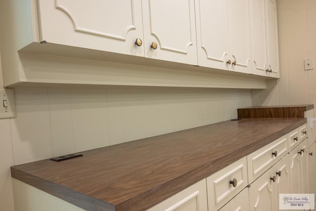 kitchen with white cabinets and wooden counters