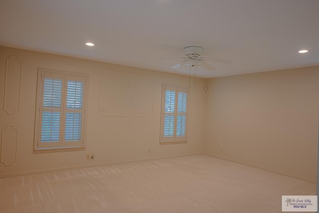 carpeted empty room featuring ceiling fan