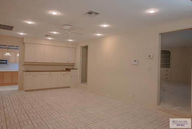 kitchen with ceiling fan and decorative light fixtures