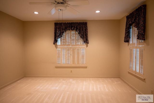 empty room featuring ceiling fan and carpet