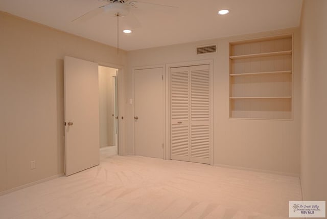 unfurnished bedroom with ceiling fan and carpet floors