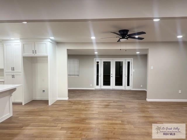 empty room featuring ceiling fan, recessed lighting, baseboards, french doors, and light wood-type flooring