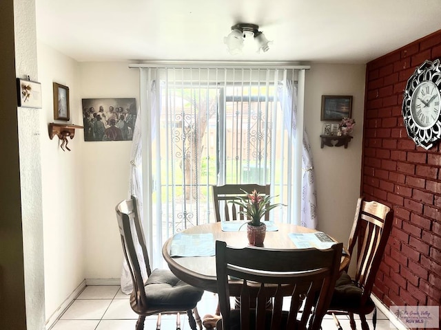 12 Palmetto Ct, Brownsville, TX 78521 - dining area with light tile patterned floors, brick wall, and baseboards