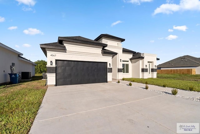 view of front of house featuring central AC and a garage