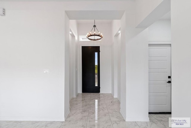 entryway with a chandelier