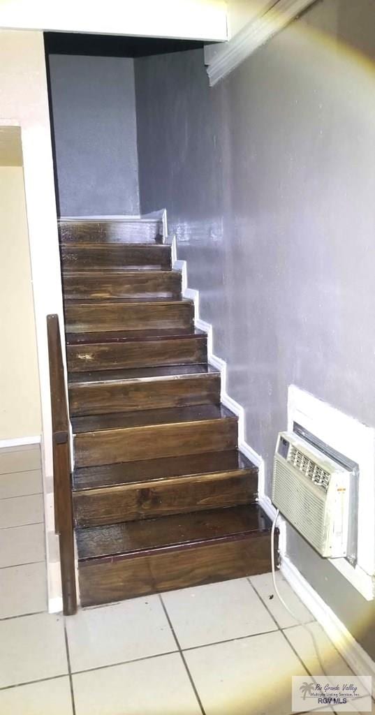 stairs featuring tile patterned floors