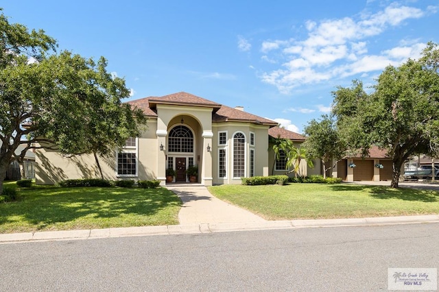 mediterranean / spanish-style house featuring a front lawn