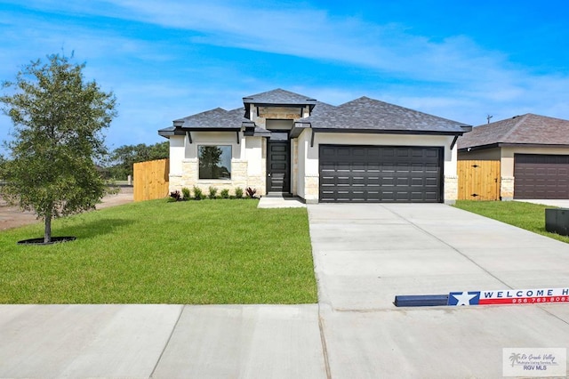 1838 Miley Ln, Harlingen, TX 78550 - prairie-style home with a garage, stone siding, concrete driveway, stucco siding, and roof with shingles