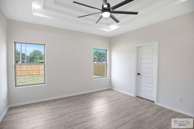 1838 Miley Ln, Harlingen, TX 78550 - spare room featuring a raised ceiling, light wood-style flooring, and ceiling fan