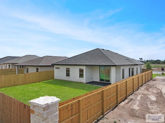 1838 Miley Ln, Harlingen, TX 78550 - rear view of property with roof with shingles, stucco siding, and a fenced backyard