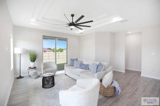 1838 Miley Ln, Harlingen, TX 78550 - living room with a tray ceiling, a ceiling fan, wood finished floors, and recessed lighting