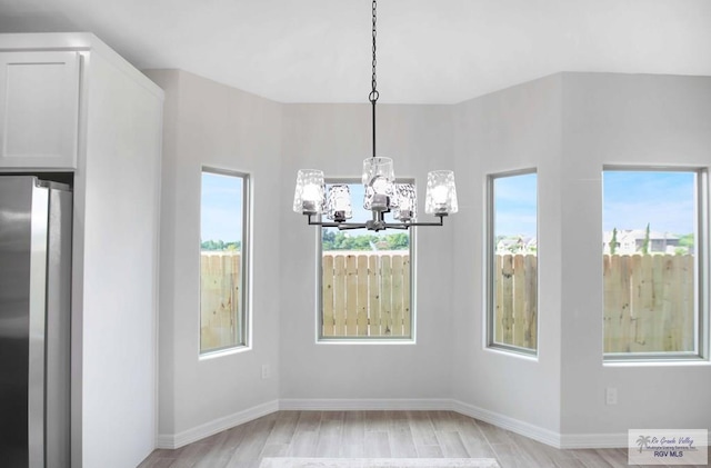 1838 Miley Ln, Harlingen, TX 78550 - unfurnished dining area with a chandelier and light wood finished floors