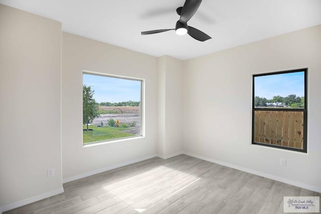 1838 Miley Ln, Harlingen, TX 78550 - unfurnished room featuring light wood-style floors, healthy amount of natural light, and a ceiling fan
