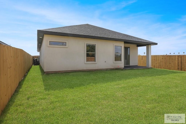 1838 Miley Ln, Harlingen, TX 78550 - back of property with roof with shingles, a fenced backyard, and stucco siding