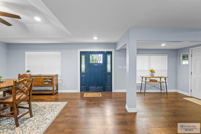 entrance foyer featuring ceiling fan and dark wood-type flooring