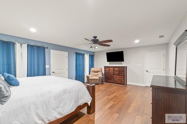 bedroom with light hardwood / wood-style flooring and ceiling fan