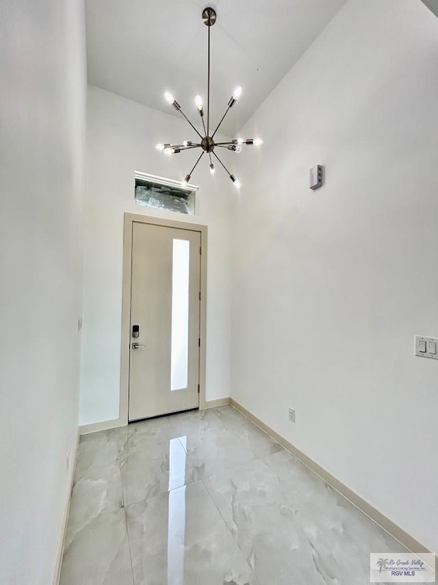 514 Oriole Dr, Los Fresnos, TX 78566 - foyer featuring a chandelier and light marble finish floors