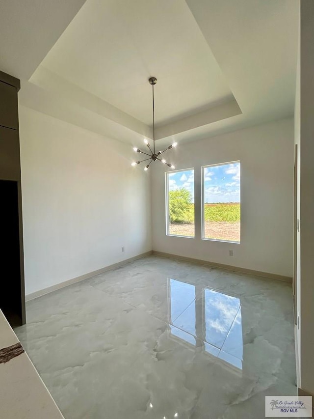 514 Oriole Dr, Los Fresnos, TX 78566 - unfurnished dining area featuring a raised ceiling, a chandelier, and concrete floors