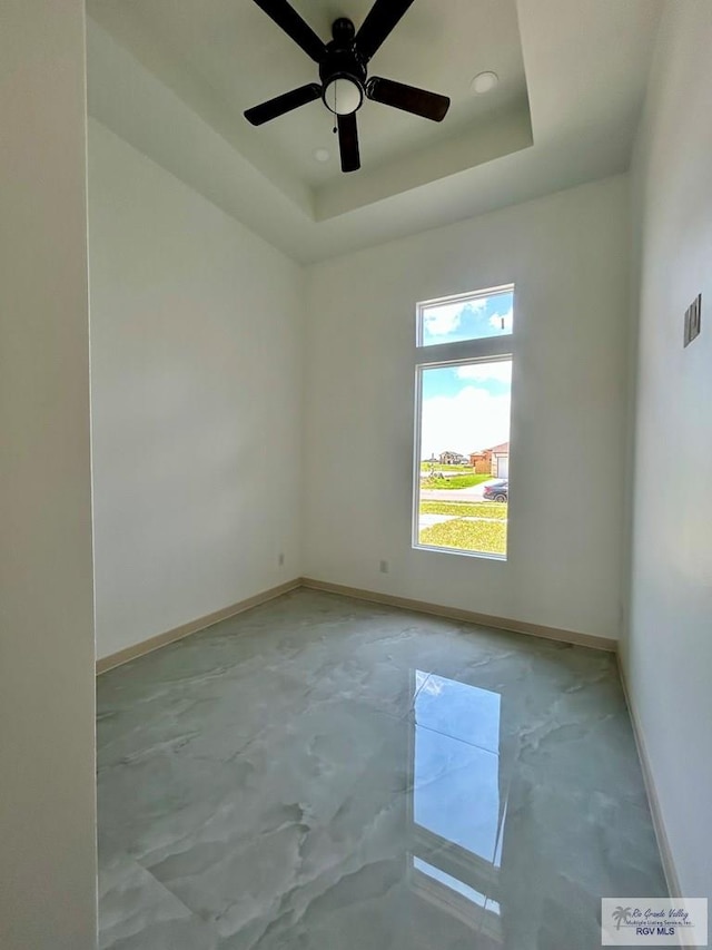514 Oriole Dr, Los Fresnos, TX 78566 - unfurnished room with concrete floors, ceiling fan, and a tray ceiling