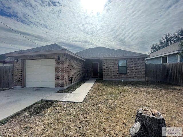 single story home with a garage and a front lawn