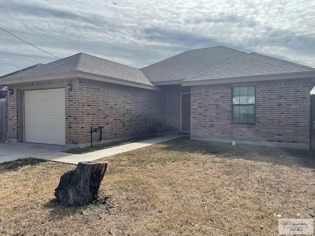 view of front of home with a garage and a front lawn