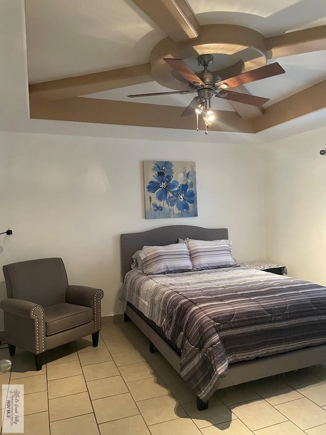 bedroom with a raised ceiling, ceiling fan, and light tile patterned flooring