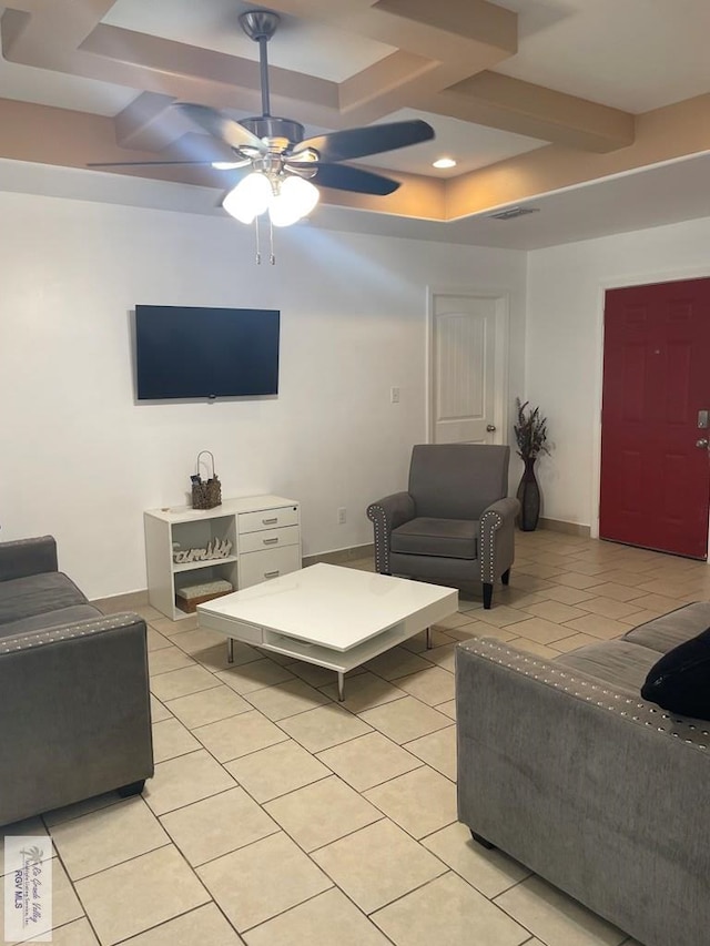 living room with ceiling fan, coffered ceiling, and light tile patterned floors