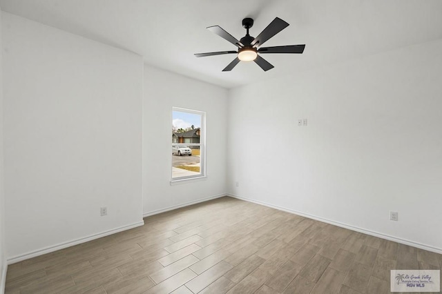 spare room featuring ceiling fan and light wood-type flooring