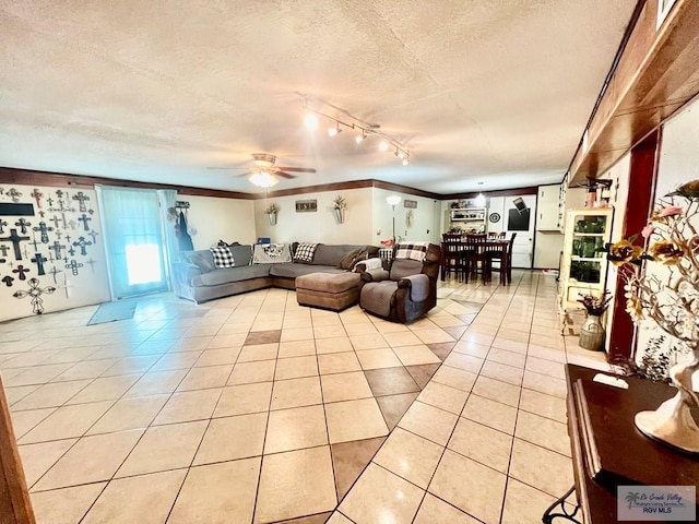 31360 Fm 1575, Los Fresnos, TX 78566 - living room featuring a textured ceiling, light tile patterned floors, track lighting, a ceiling fan, and crown molding