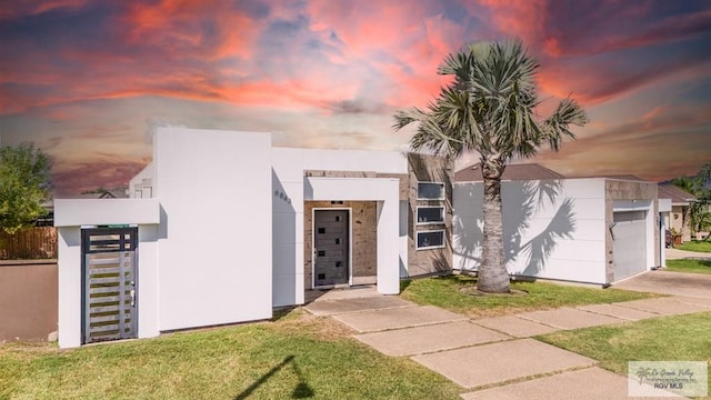 view of front facade with a garage and a yard