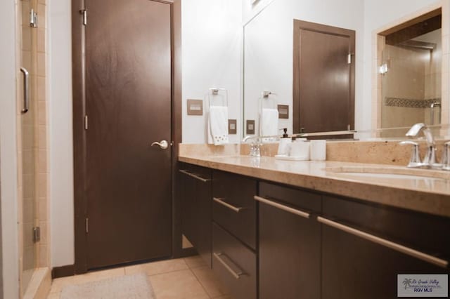 bathroom with vanity, tile patterned floors, and an enclosed shower