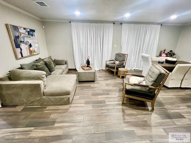 living room featuring ornamental molding and visible vents