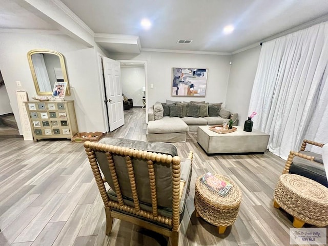 living room featuring crown molding and hardwood / wood-style floors