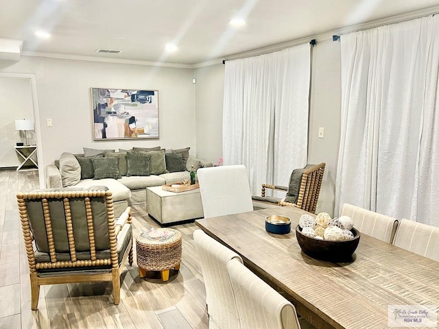 dining room with visible vents, ornamental molding, wood finished floors, and recessed lighting