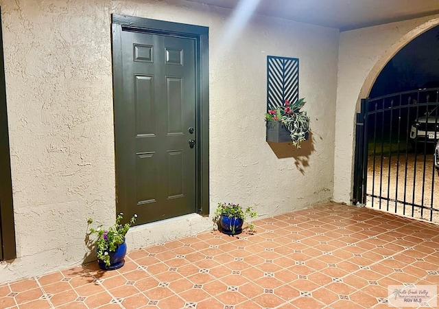 view of exterior entry with stucco siding