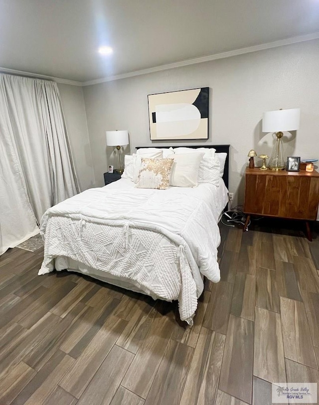 bedroom featuring ornamental molding and dark wood-type flooring