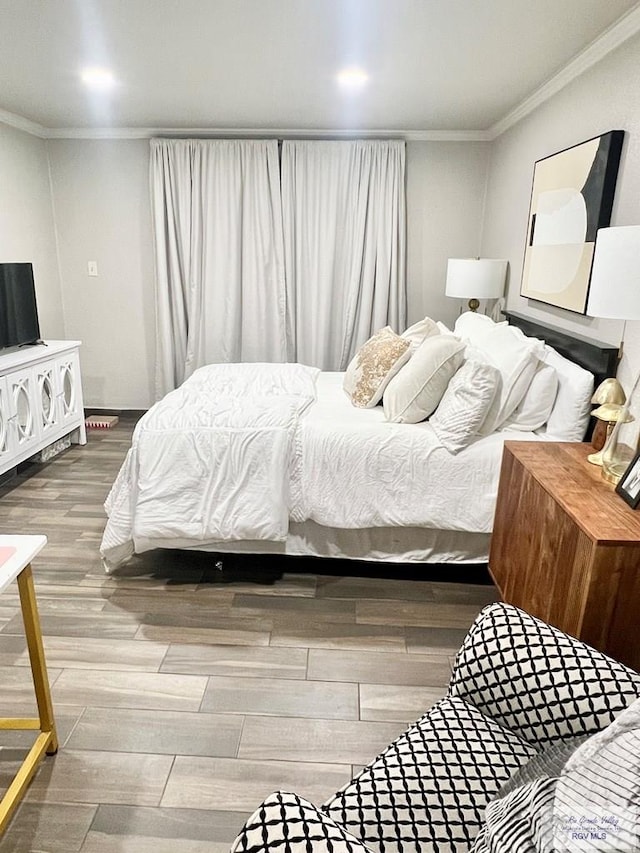 bedroom featuring hardwood / wood-style floors and ornamental molding