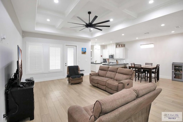 living room with ceiling fan, light hardwood / wood-style flooring, beamed ceiling, and coffered ceiling