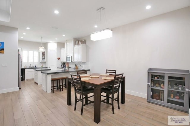 dining area with light hardwood / wood-style flooring